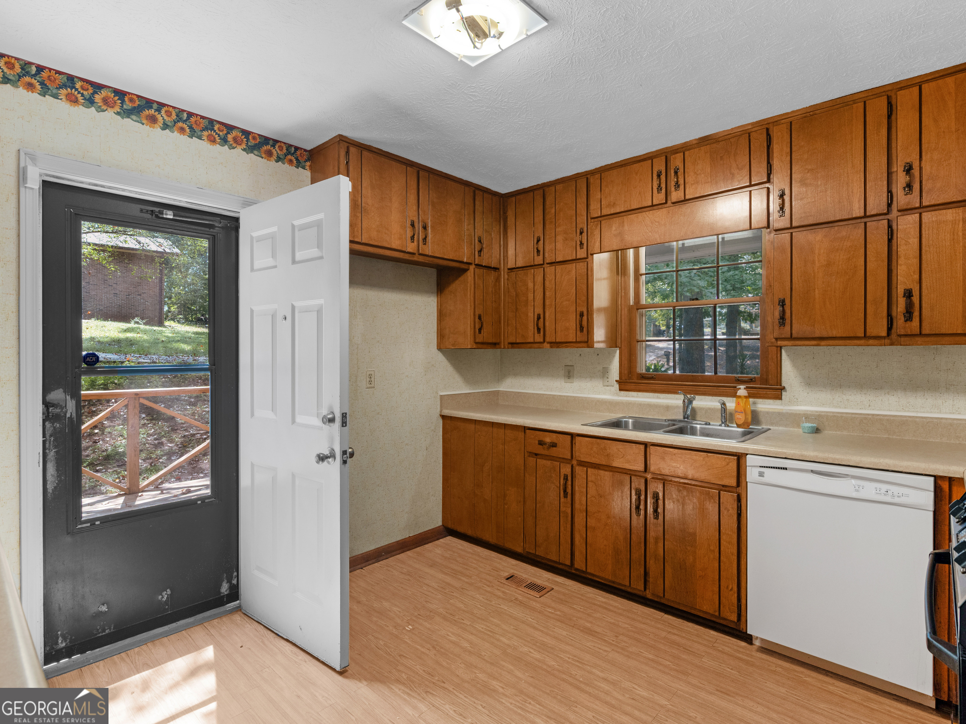 8294 Winston Way Jonesboro, GA 30236 - Photo 11 of 62 a kitchen with stainless steel appliances granite countertop a sink and cabinets with wooden floor