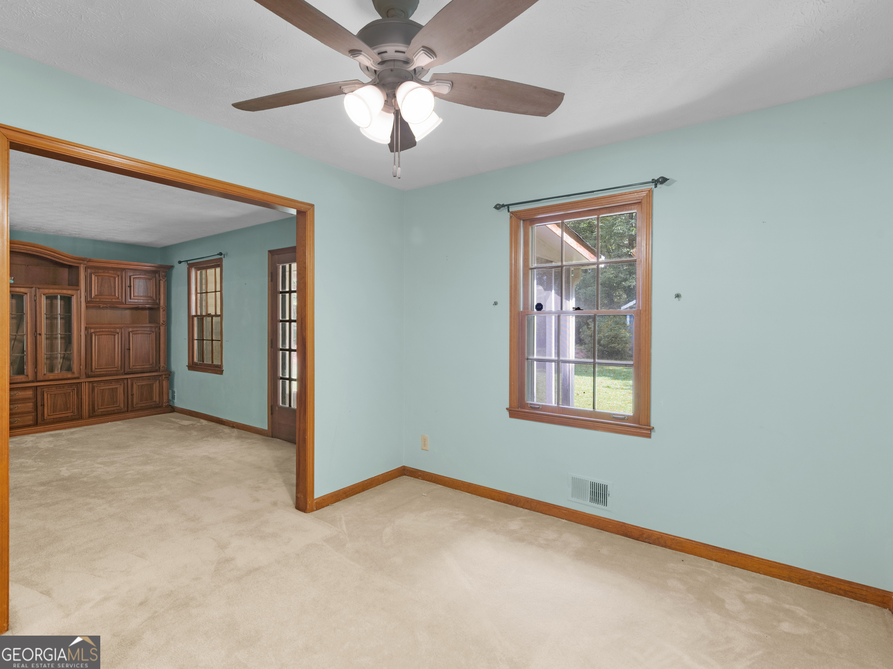 8294 Winston Way Jonesboro, GA 30236 - Photo 16 of 62 an empty room with chandelier fan and windows