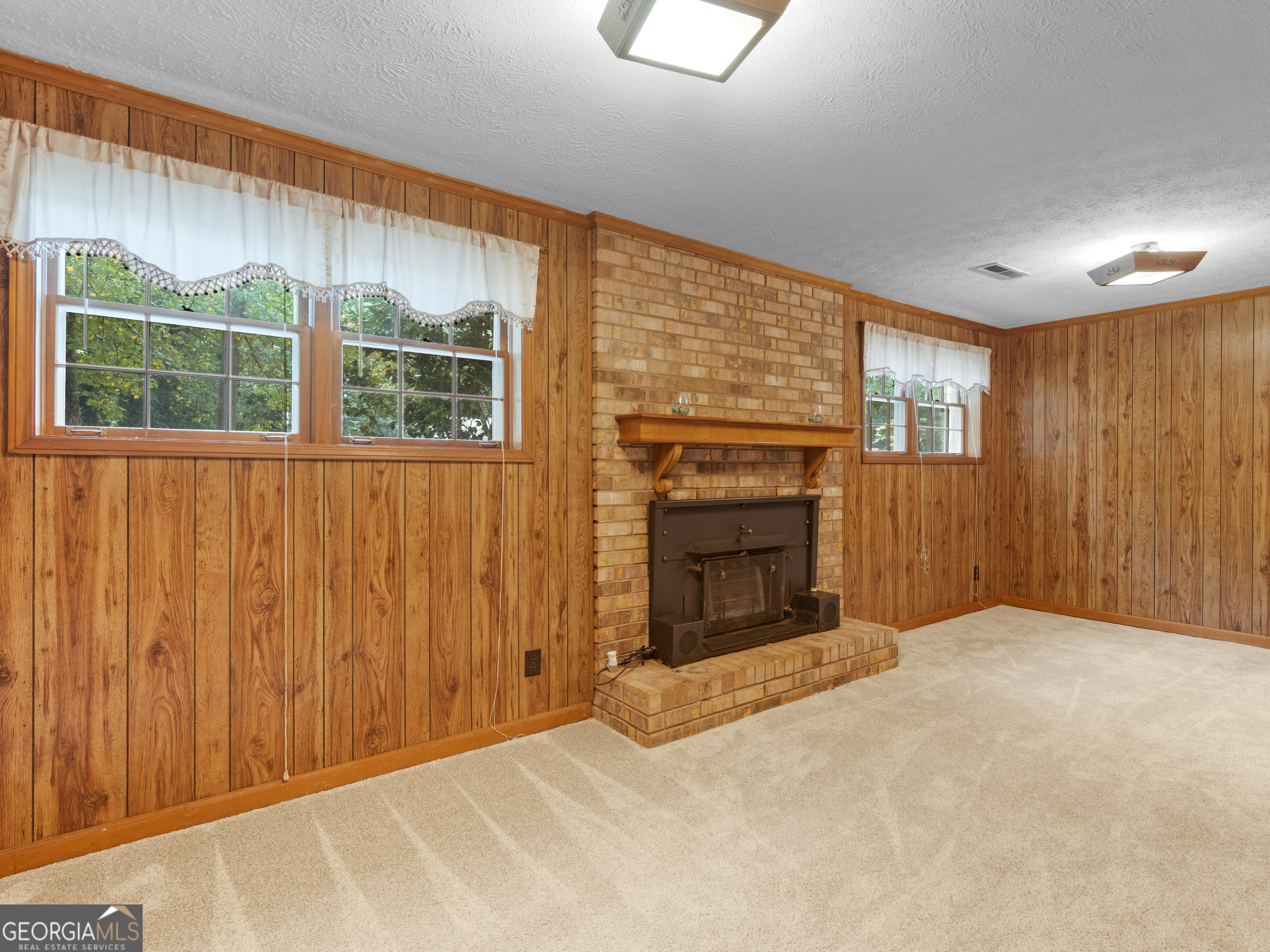 8294 Winston Way Jonesboro, GA 30236 - Photo 23 of 62 a view of an empty room with a fireplace and a window