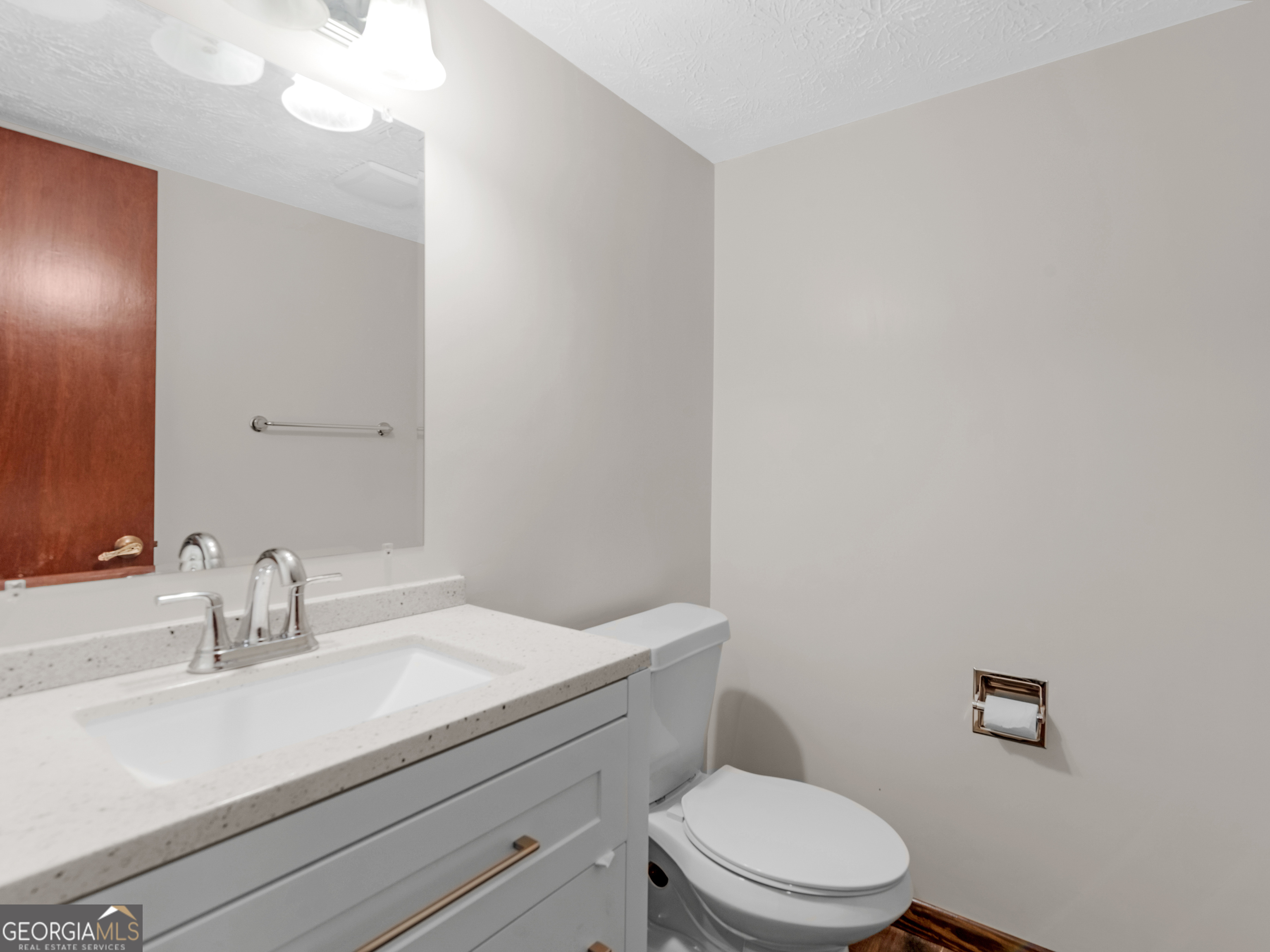 8294 Winston Way Jonesboro, GA 30236 - Photo 27 of 62 a bathroom with a toilet a sink and mirror