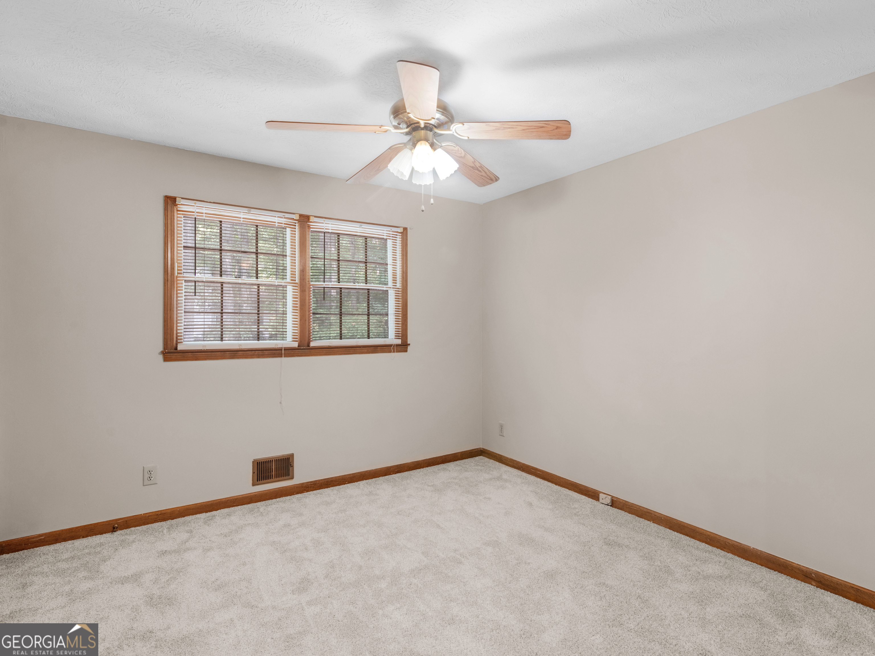 8294 Winston Way Jonesboro, GA 30236 - Photo 28 of 62 an empty room with a window and a fan