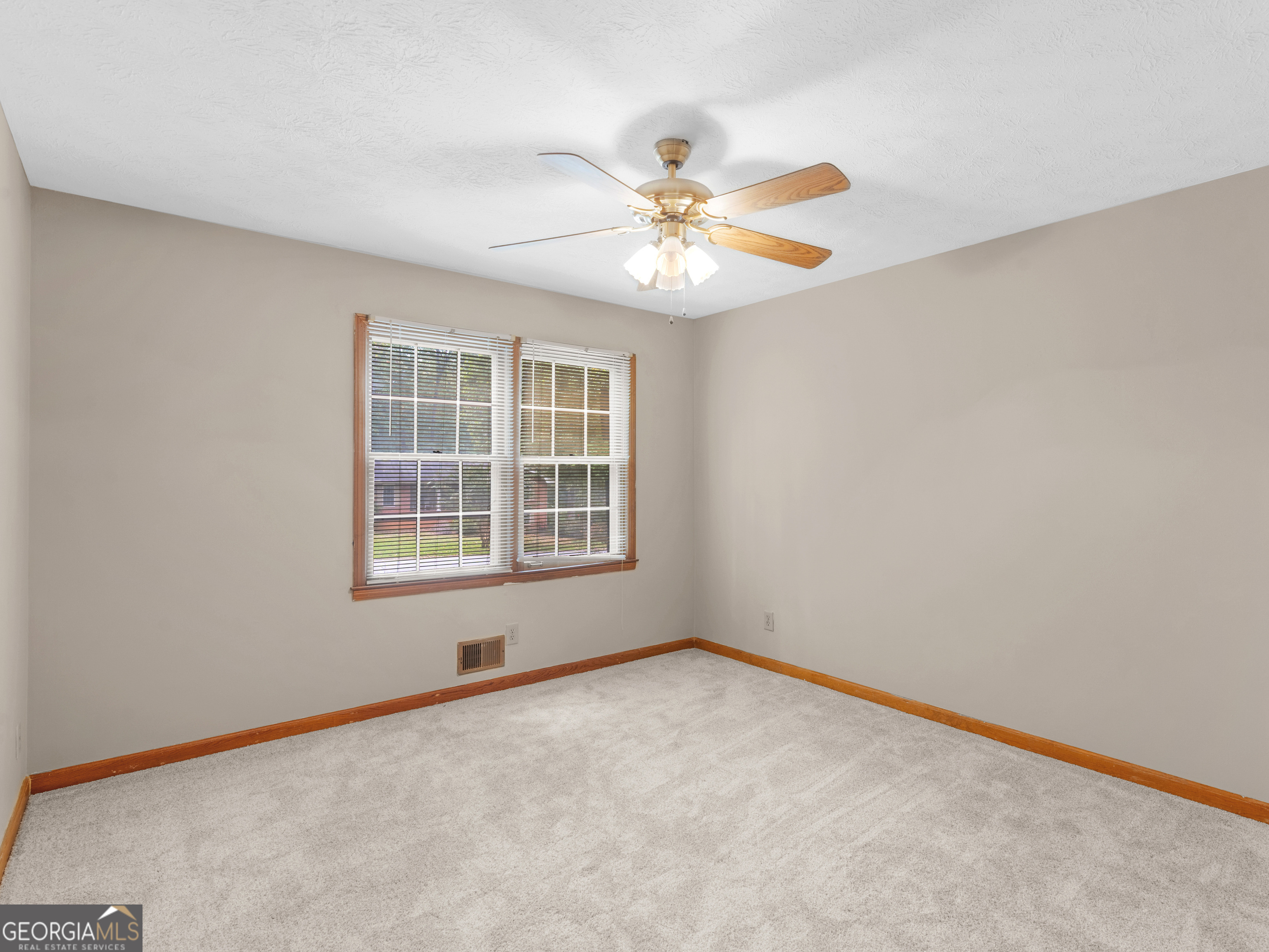 8294 Winston Way Jonesboro, GA 30236 - Photo 32 of 62 an empty room with windows and fan