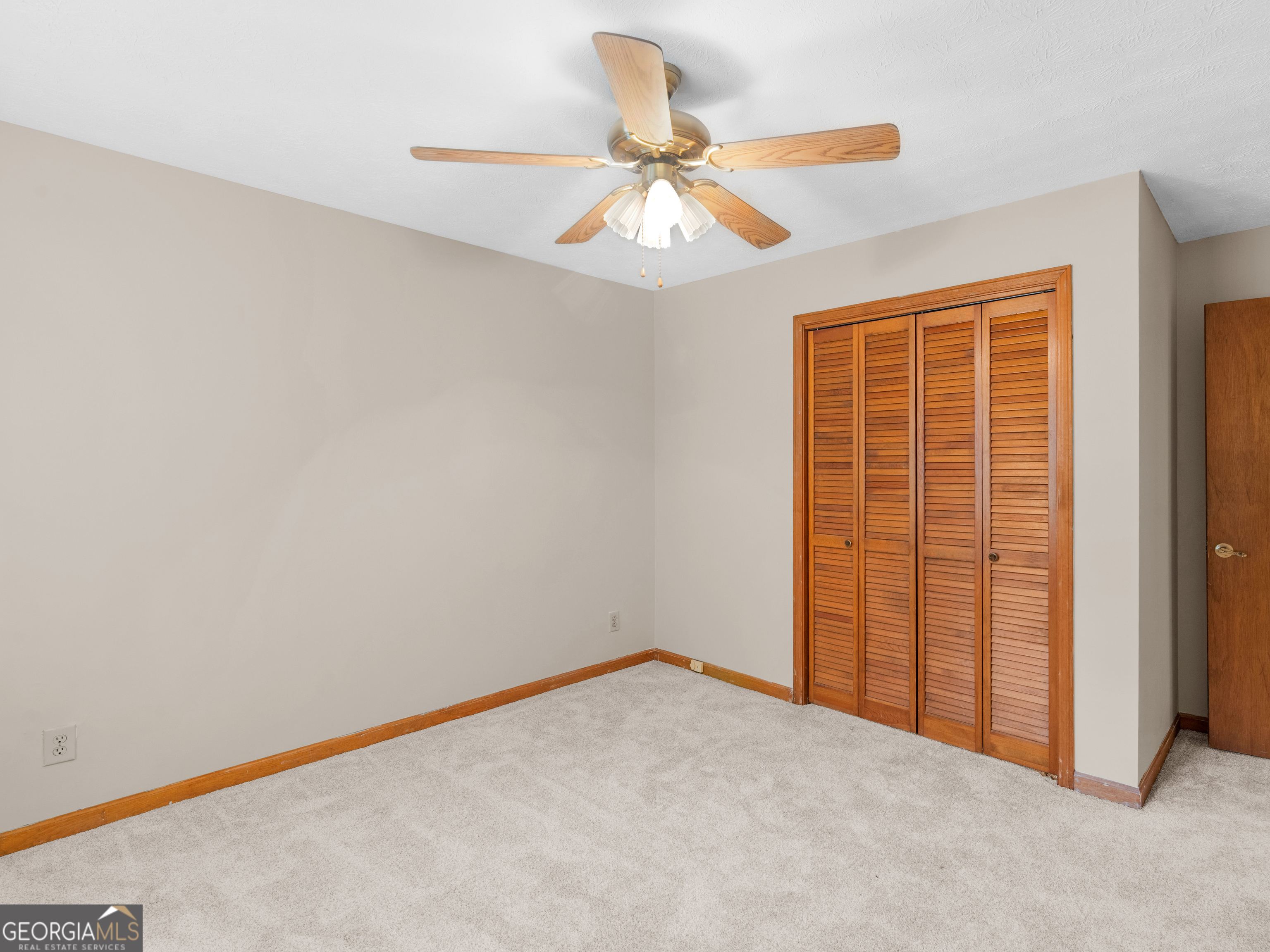 8294 Winston Way Jonesboro, GA 30236 - Photo 35 of 62 an empty room with a ceiling fan and a window