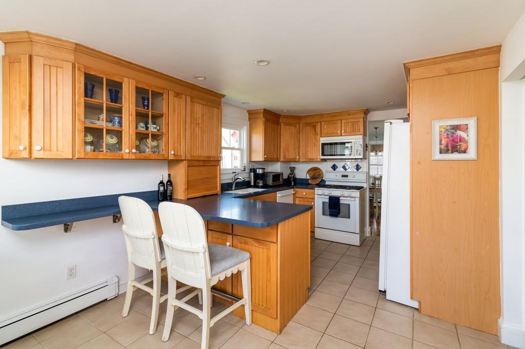 7 Mildred Street Hull, MA 02045 - Photo 13 of 26 a kitchen with a stove a sink and a refrigerator