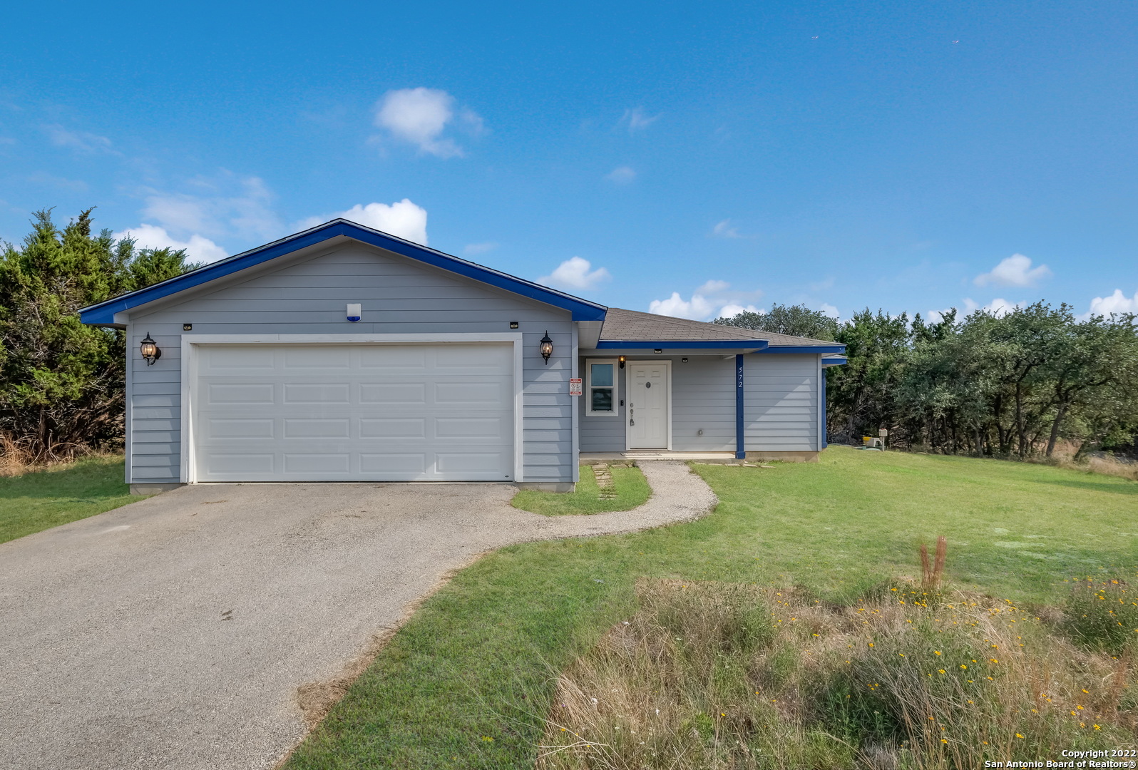 572 Hillside Drive Spring Branch, TX 78070 - Photo 1 of 1 a view of a house with a yard and garage