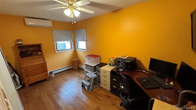 a view of a workspace with furniture and a window