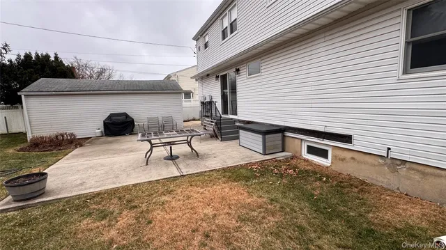 a view of a patio with table and chairs