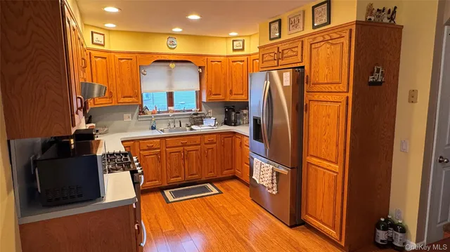 a kitchen with stainless steel appliances granite countertop a refrigerator and a stove