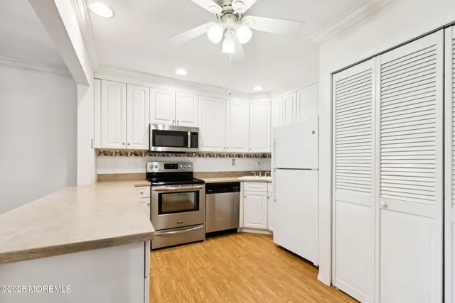 a kitchen with stainless steel appliances granite countertop a stove and a refrigerator