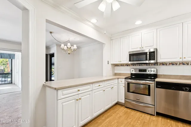 a kitchen with stainless steel appliances granite countertop a stove and a microwave