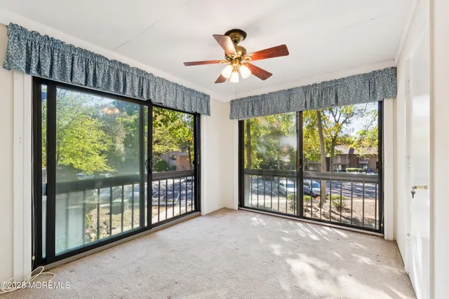 a view of a big room with balcony ceiling fan