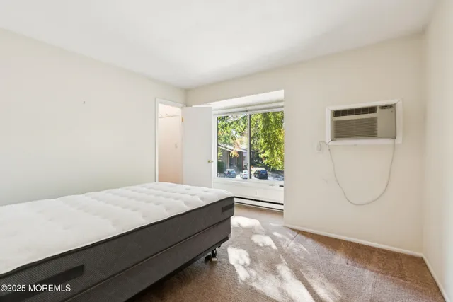 a room with a bed a mirror and a window