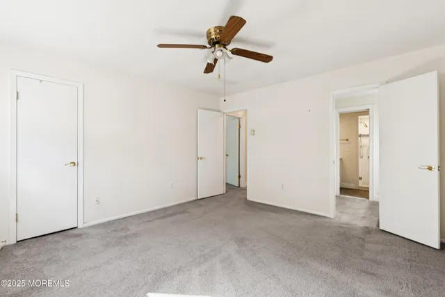 a view of an empty room with a ceiling fan