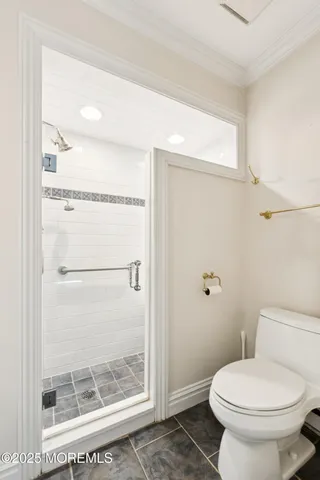 a bathroom with a toilet and a shower