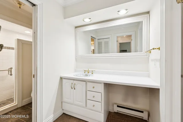 a bathroom with a sink vanity and mirror