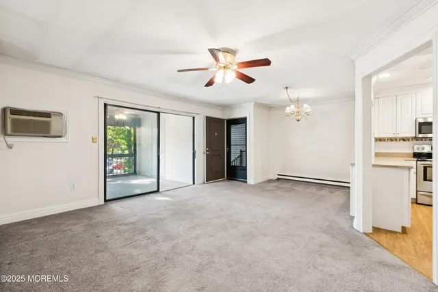 a view of a livingroom with a ceiling fan and window