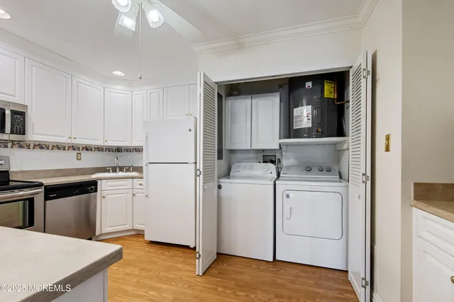 a kitchen with a refrigerator sink stove and cabinets