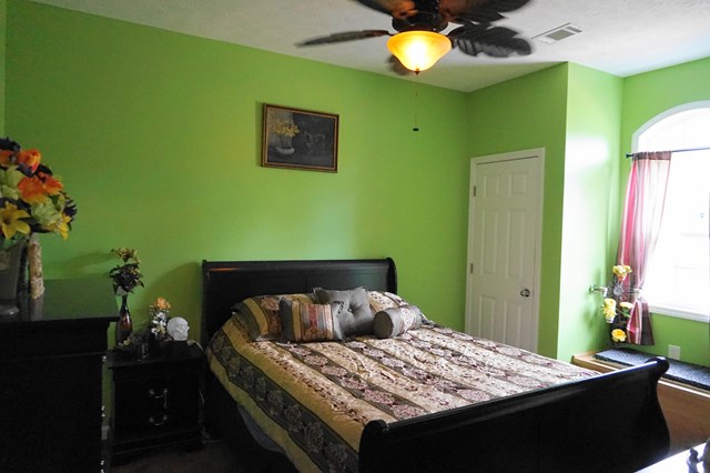 37 Copper Road Seale, AL 36875 - Photo 18 of 42 a bedroom with a bed and a chandelier
