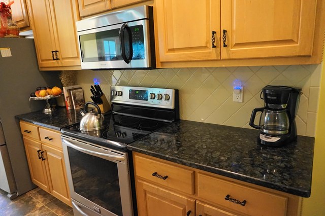 37 Copper Road Seale, AL 36875 - Photo 21 of 42 a kitchen with stainless steel appliances granite countertop a sink and cabinets