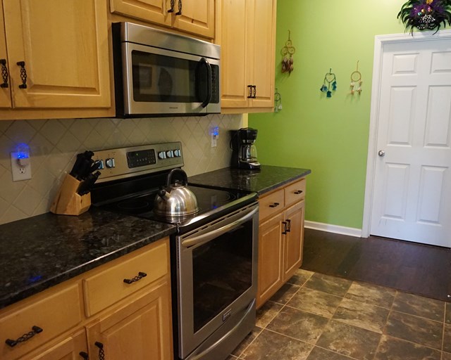 37 Copper Road Seale, AL 36875 - Photo 22 of 42 a kitchen with granite countertop white cabinets and stainless steel appliances