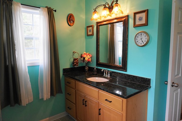 37 Copper Road Seale, AL 36875 - Photo 32 of 42 a bathroom with a granite countertop sink and a mirror