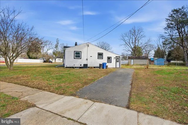 a front view of house with yard and trees around