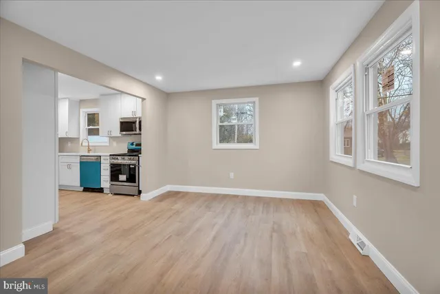 a view of a livingroom with furniture wooden floor and windows