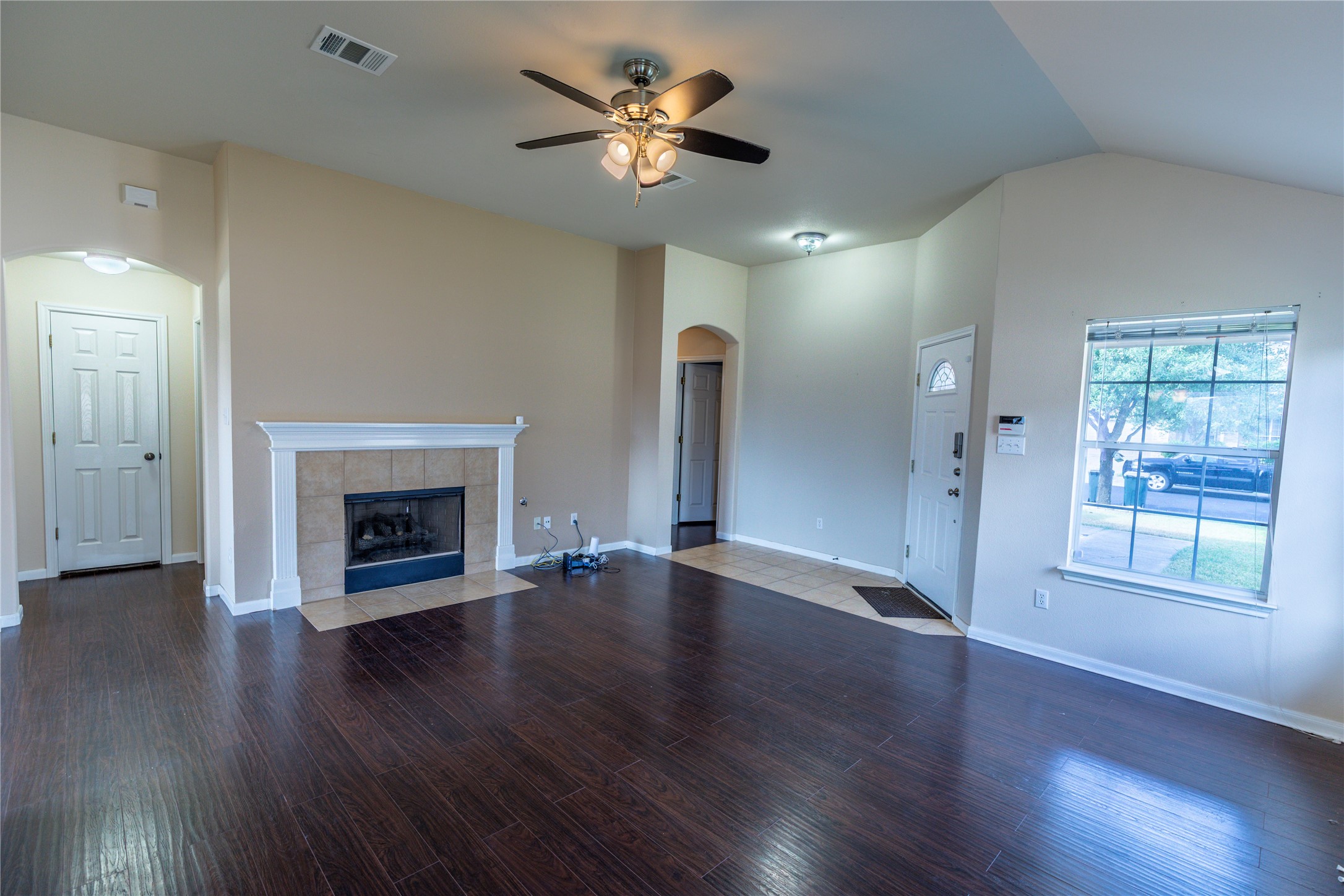 102 Thompson Trail Bastrop, TX 78602 - Photo 2 of 18 a view of an empty room with window and wooden floor