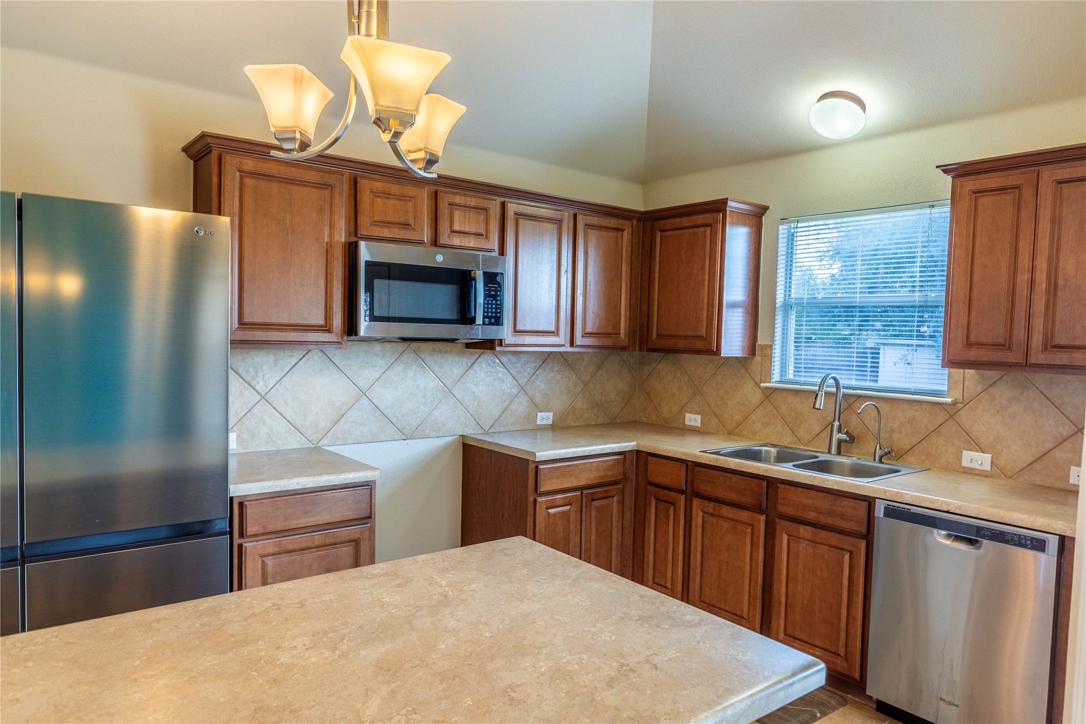 102 Thompson Trail Bastrop, TX 78602 - Photo 7 of 18 a kitchen with a sink cabinets and window