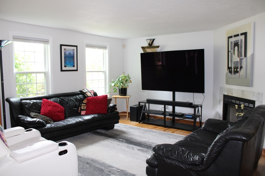 27 Gretchen Way Raynham, MA 02767 - Photo 2 of 20 a living room with furniture a flat screen tv and a window