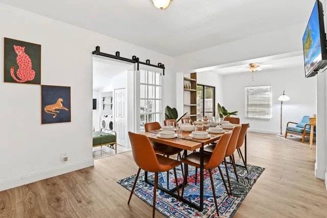 a view of a dining room with furniture and wooden floor