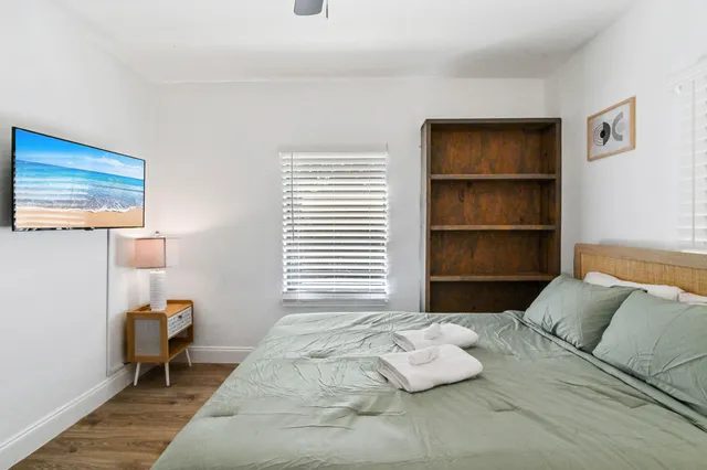 a bedroom with a bed and a window