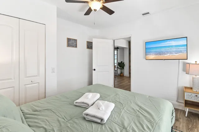a bedroom with a bed and a chandelier