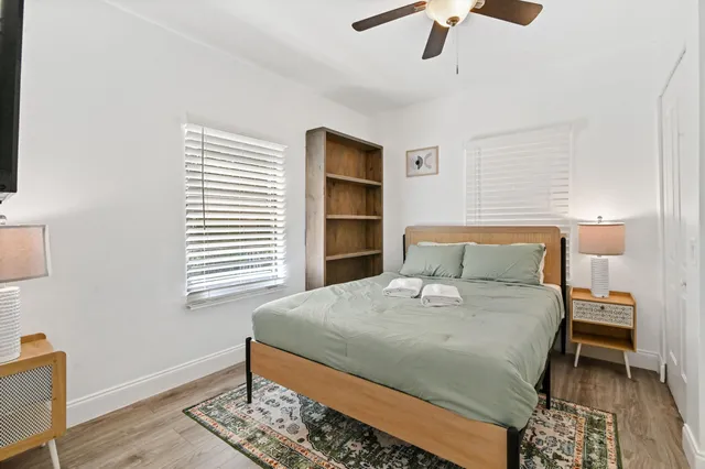a large bed sitting in a bedroom next to a window