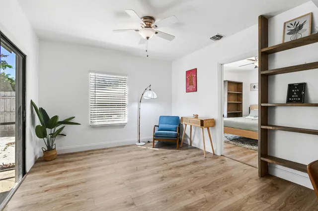a living room with furniture and a wooden floor
