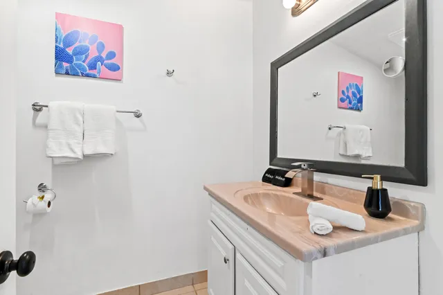 a bathroom with a sink vanity and a mirror