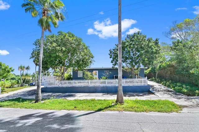 a front view of a house with plants