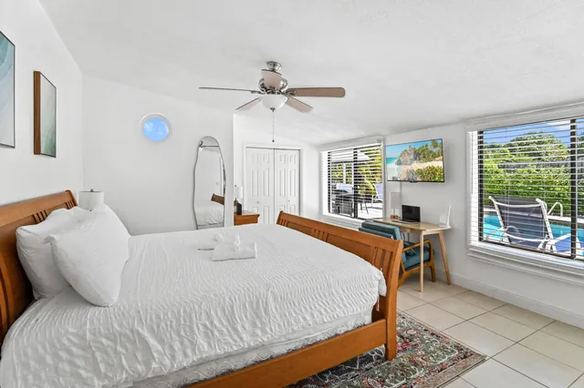 a bed sitting in a bedroom next to a window