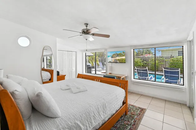 a bedroom with a bed and a large window
