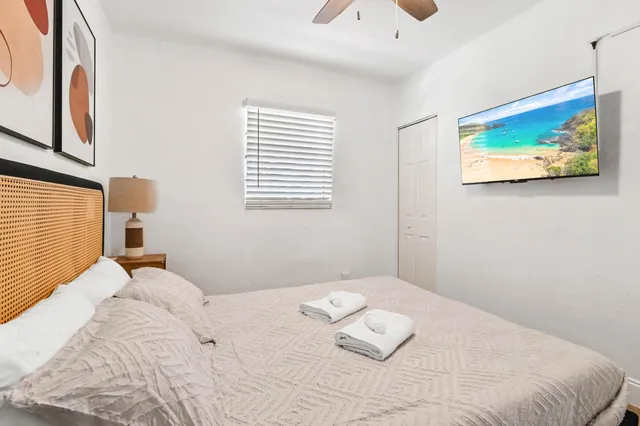 a bedroom with a bed and a painting on the wall