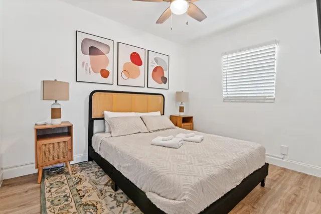 a bedroom with a bed and a chandelier