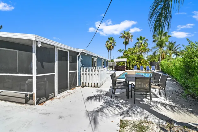 a view of a patio with table and chairs and potted plants
