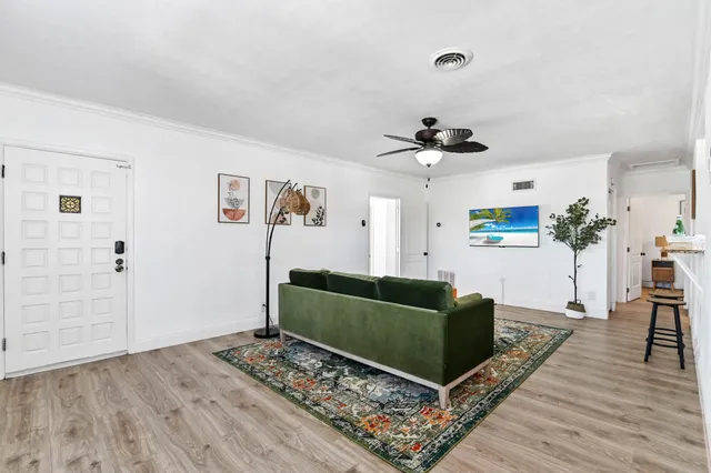 a living room with furniture and a wooden floor