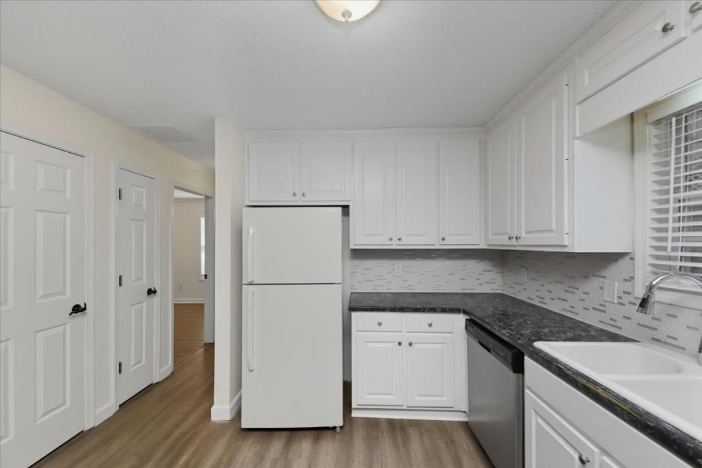 2515 Lakeview Trail Cumming, GA 30041 - Photo 12 of 27 a kitchen with a refrigerator sink and cabinets