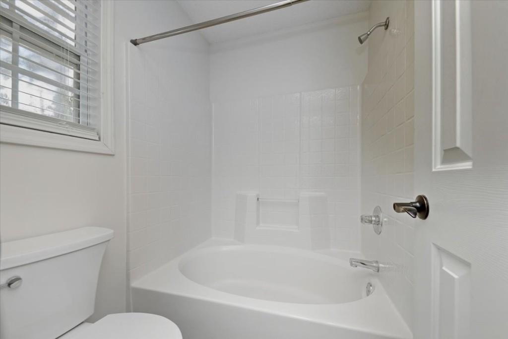 2515 Lakeview Trail Cumming, GA 30041 - Photo 14 of 27 a white bath tub sitting next to a white toilet and a shower