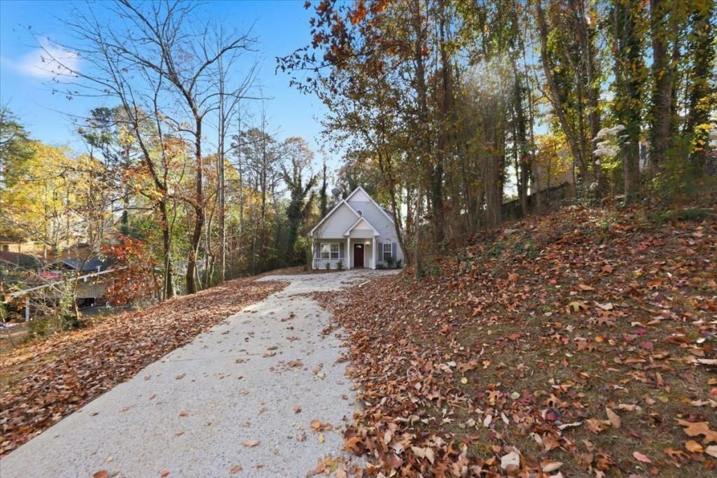 2515 Lakeview Trail Cumming, GA 30041 - Photo 2 of 27 a dirt road with trees in front of it