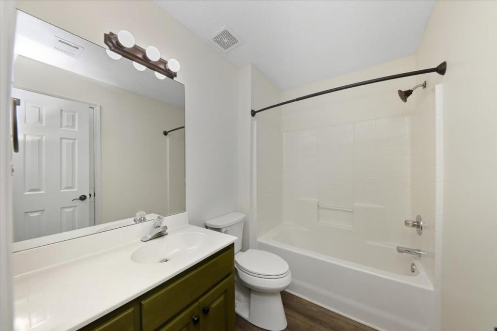 2515 Lakeview Trail Cumming, GA 30041 - Photo 21 of 27 a bathroom with a sink a toilet and shower