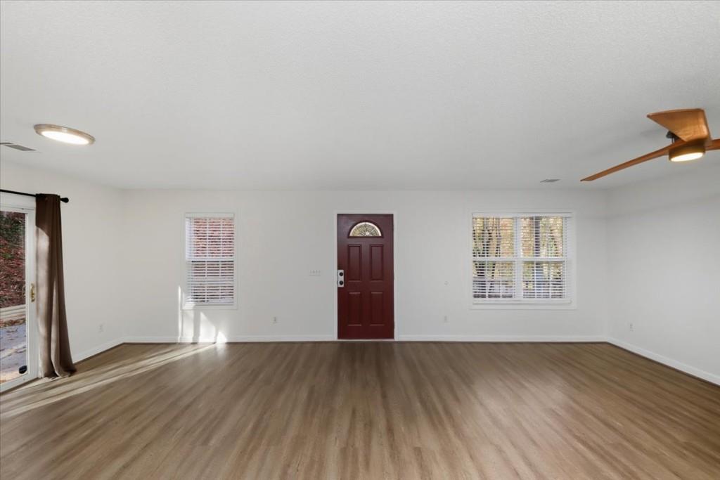 2515 Lakeview Trail Cumming, GA 30041 - Photo 5 of 27 an empty room with wooden floor and windows