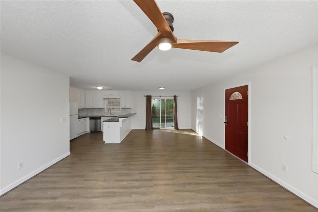 2515 Lakeview Trail Cumming, GA 30041 - Photo 6 of 27 a view of an empty room with window and wooden floor