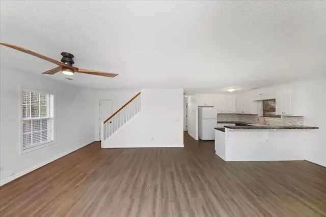 a view of kitchen with sink and wooden floor